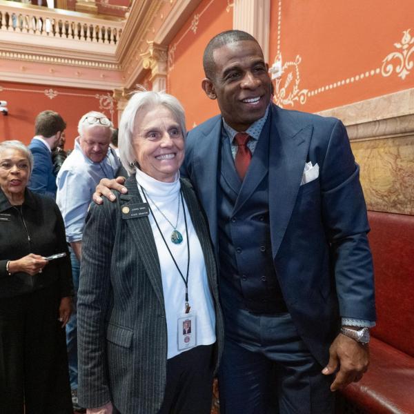 State Senator Joann Ginal poses for a photo with Deion Sanders